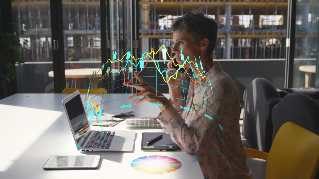 Woman on phone typing laptop while summoning AR charts then swiping, turning for business analysis