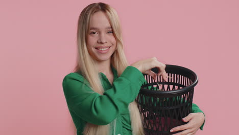 woman holding a trash can