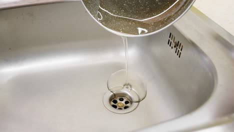 macro shot of pouring down used oil on the drains