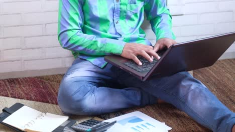 young man working on laptop at home