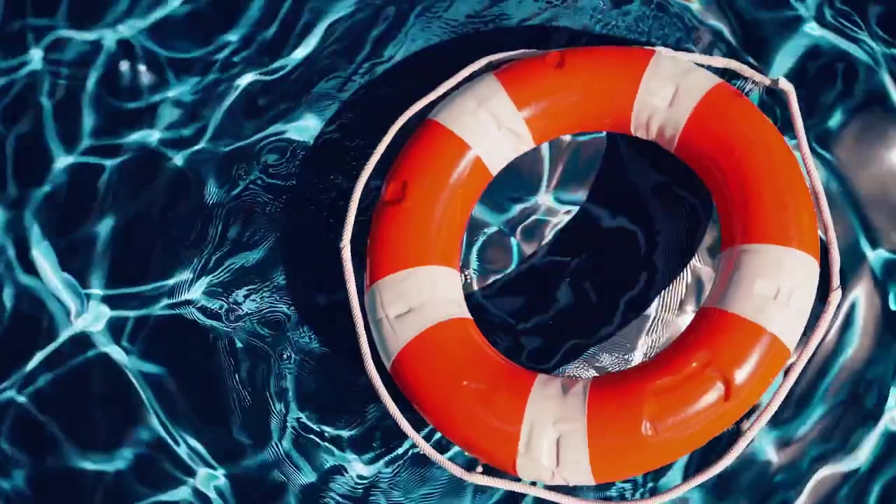 Orange and White Lifebuoy Floating in a Blue Swimming Pool