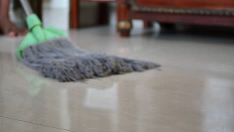 cleaning tiles floor with mop