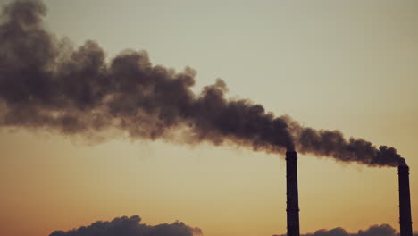 smoking pipes making clouds. multiple exposure of poor environment in cityscape pollution with heavy smoke from industrial chimneys