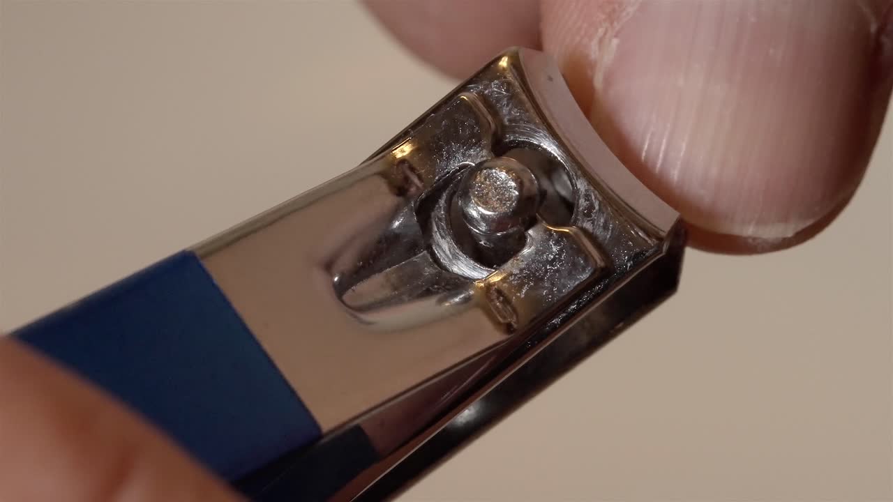Clipping Fingernails with Nail Clipper Close Up