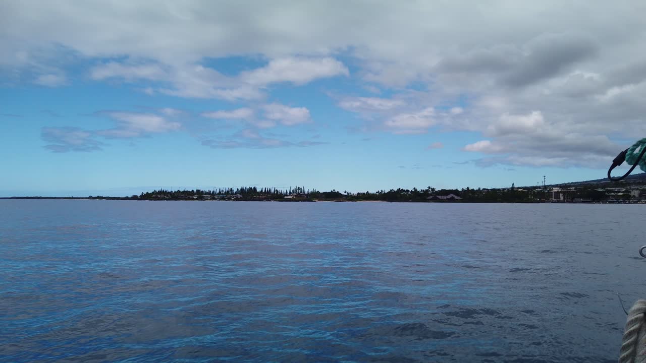 Gimbal wide POV shot from a moving boat heading towards Kailua-Kona on the island of Hawai'i