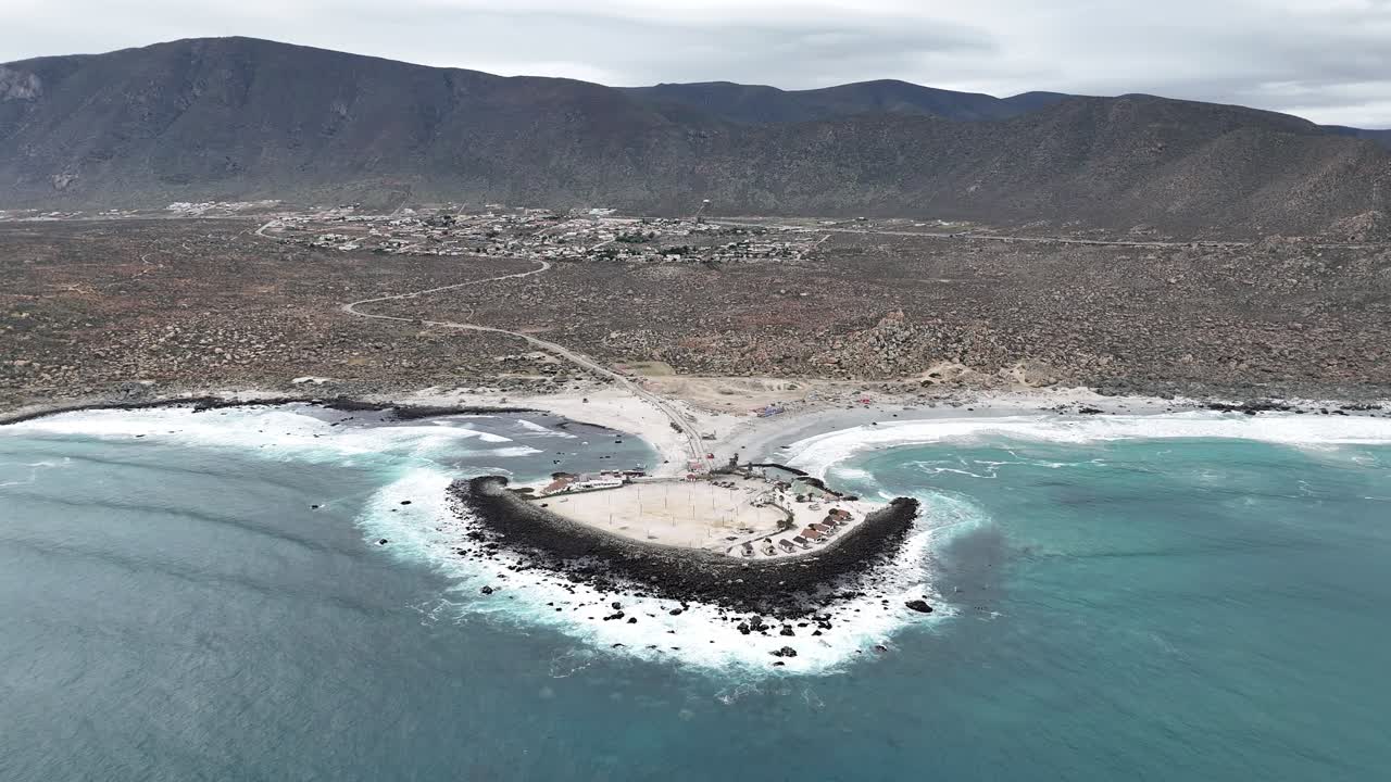 Aerial View of a Coastal Peninsula with Town and Mountains