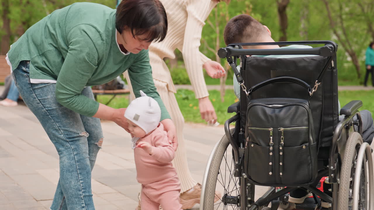 Little One Moves With Gentle Aid Nearby, Young Child Steps Forward With Compassionate Support Nearby, Toddler Progresses Forward As Kind Friends Provide Encouraging And Gentle Assistance