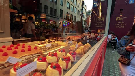 colorful cakes and pastries in a shop window