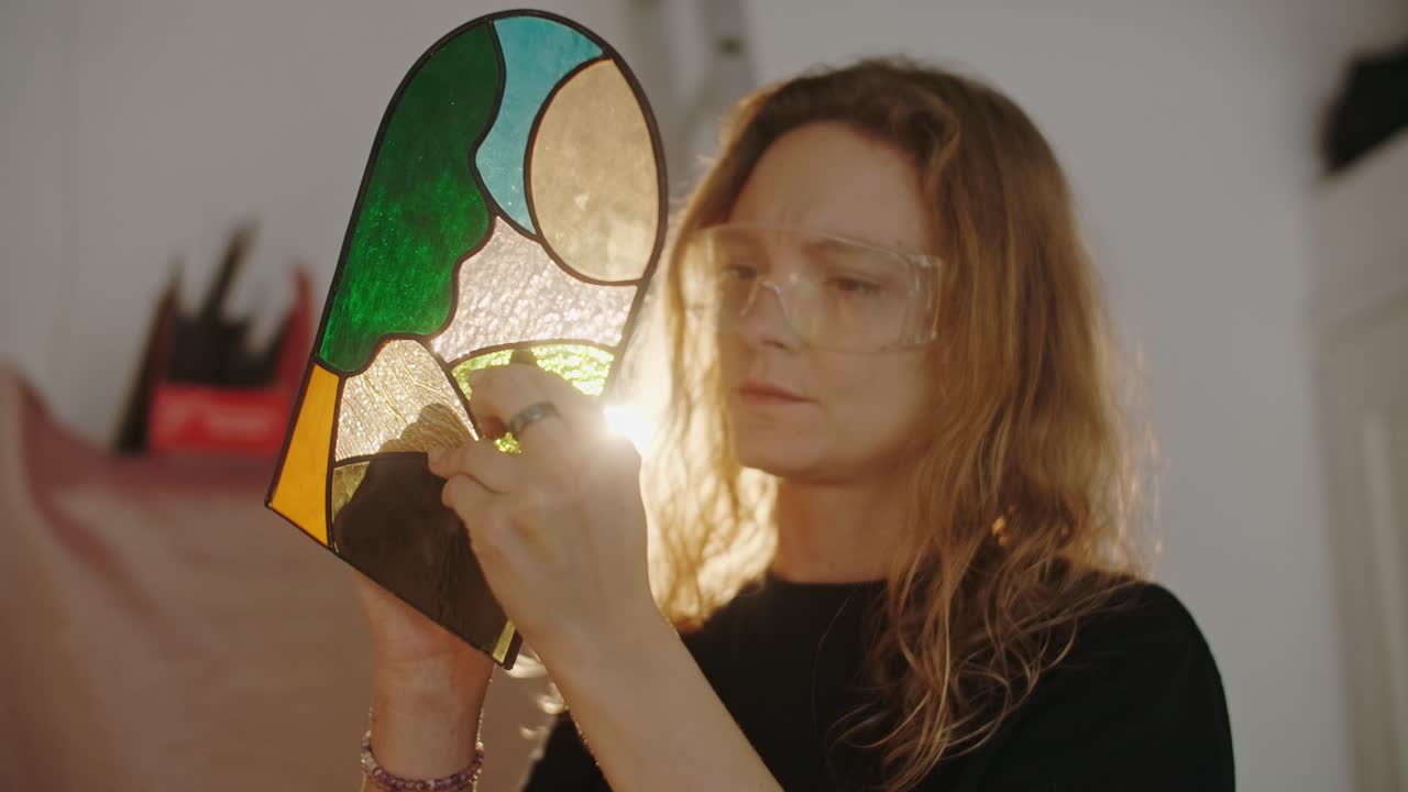 Woman crafting stained glass art