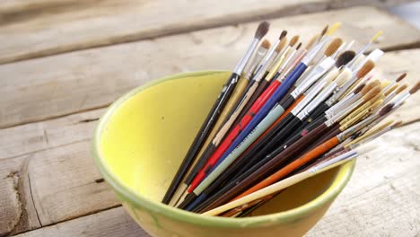 various paintbrush arranged in bowl