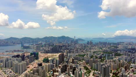 Hong-Kong-bay-and-skyline-with-skyscrapers,-high-altitude-wide-shot