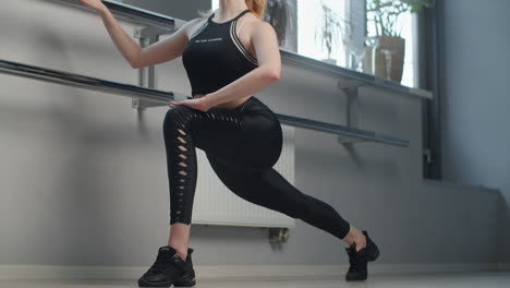 woman stretching at barre