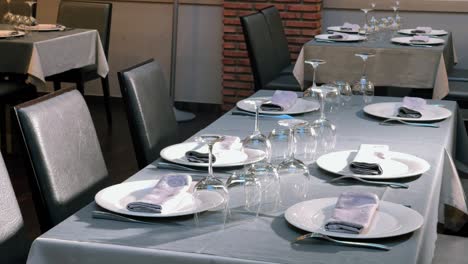 general view of spanish restaurant's dining room with paintings decorating the brick walls