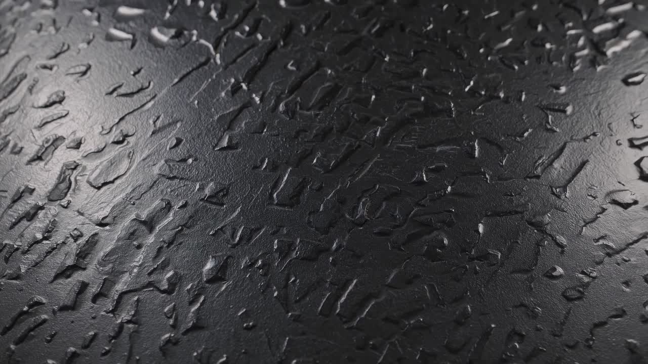 Video en primer plano de superficie negra texturizada con acabado brillante