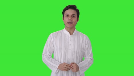 happy and excited indian man talking to someone green screen