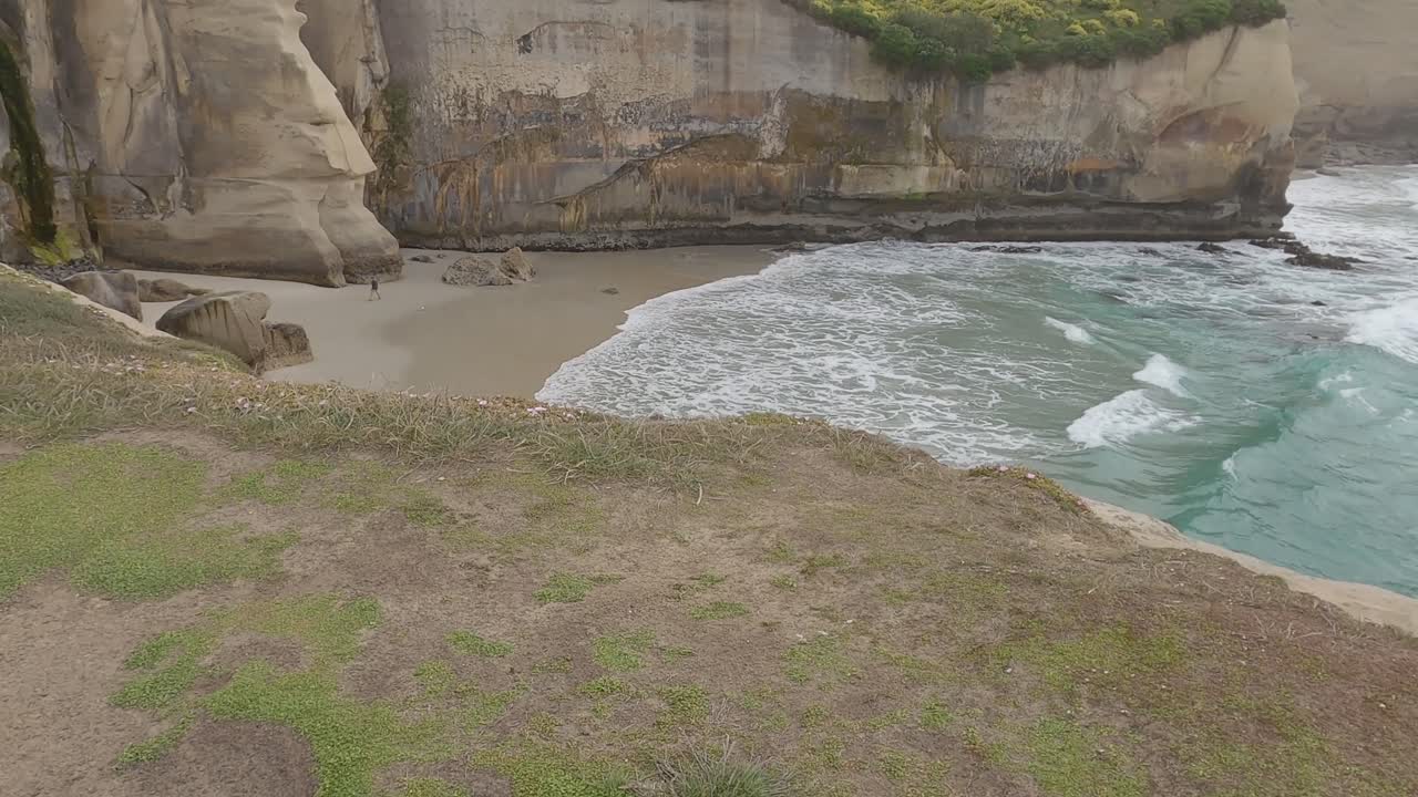 Slow walk across headland revealing amazing sandstone cliffs - Tunnel Beach Track, Dunedin