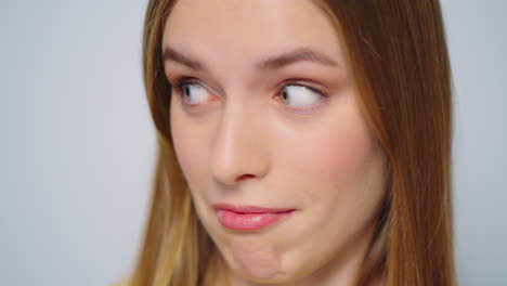 Closeup-excited-woman-looking-at-camera-on-grey-background-in-studio.