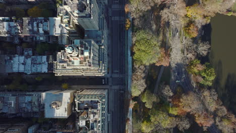 Aerial-birds-eye-overhead-top-down-view-of-buildings-and-street-along-Central-park.-Two-towers-of-historical-San-Remo-building.-Manhattan,-New-York-City,-USA