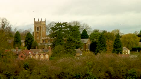 Looking-across-the-fields-in-rural-Leicestershire,-England,-towards-the-village-of-Scalford-and-Saint-Egelwin-church