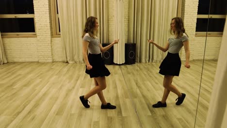 slow motion talented teenage female dancer dancing in front of a mirror