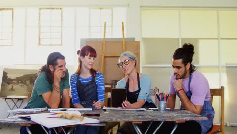 Group-of-artist-using-digital-tablet-at-table-4k