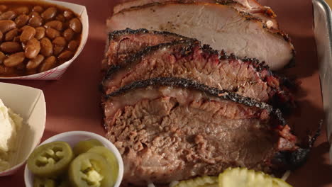 A-traditionalTexas-barbecue-two-meat-plate-with-moist-brisket-and-turkey-pinto-beans-potato-salad,-slider-close-up-4K