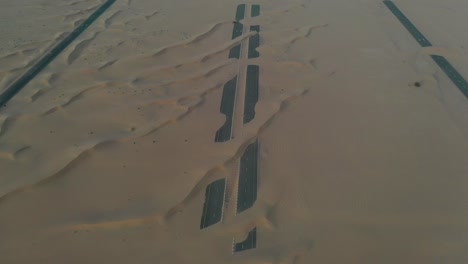 4k drone footage, a road between desert, dubai’s half desert road, geological landscape of high dune desert in the united arab emirates, drone videos