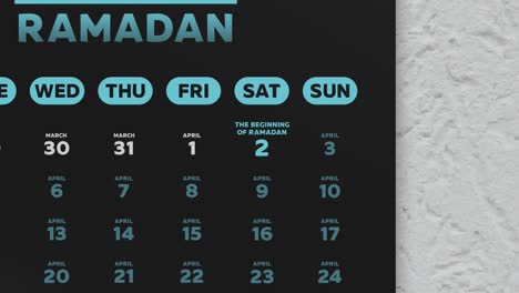 close-up of a black beautiful wall calendar page with a schedule of ramadan fasting days 2022 and the camera moves to eid al-fitr date