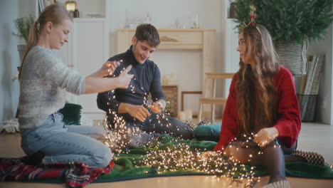 man and women sorting tangled glowing lights