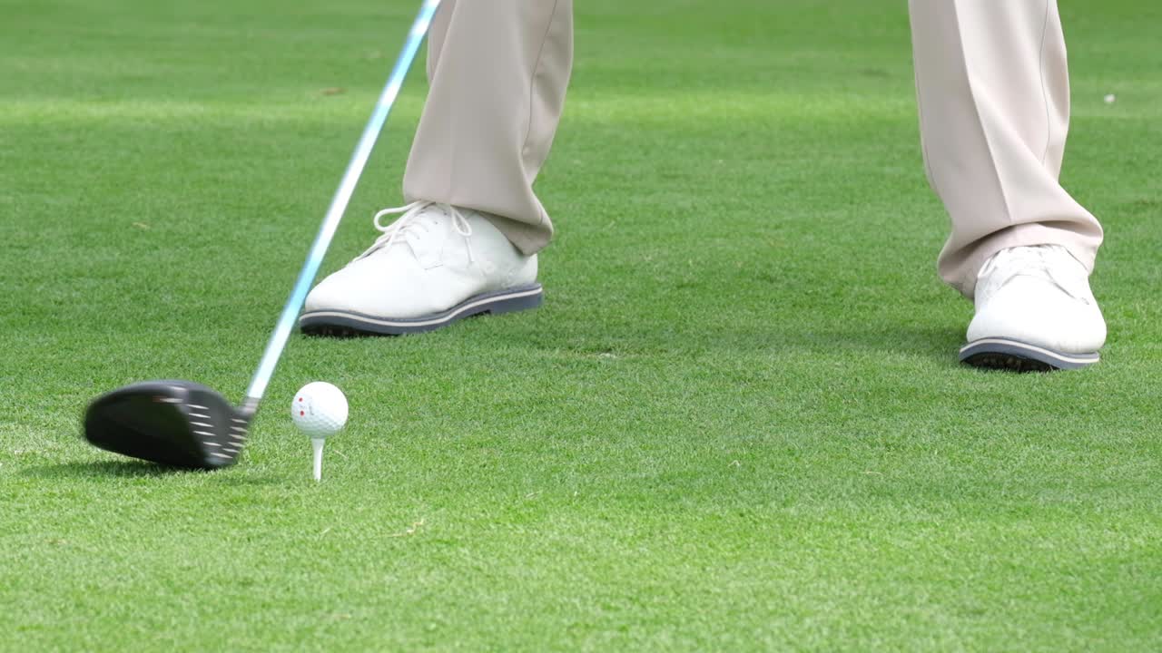 Slow motion golfer taking shot on the golf course.