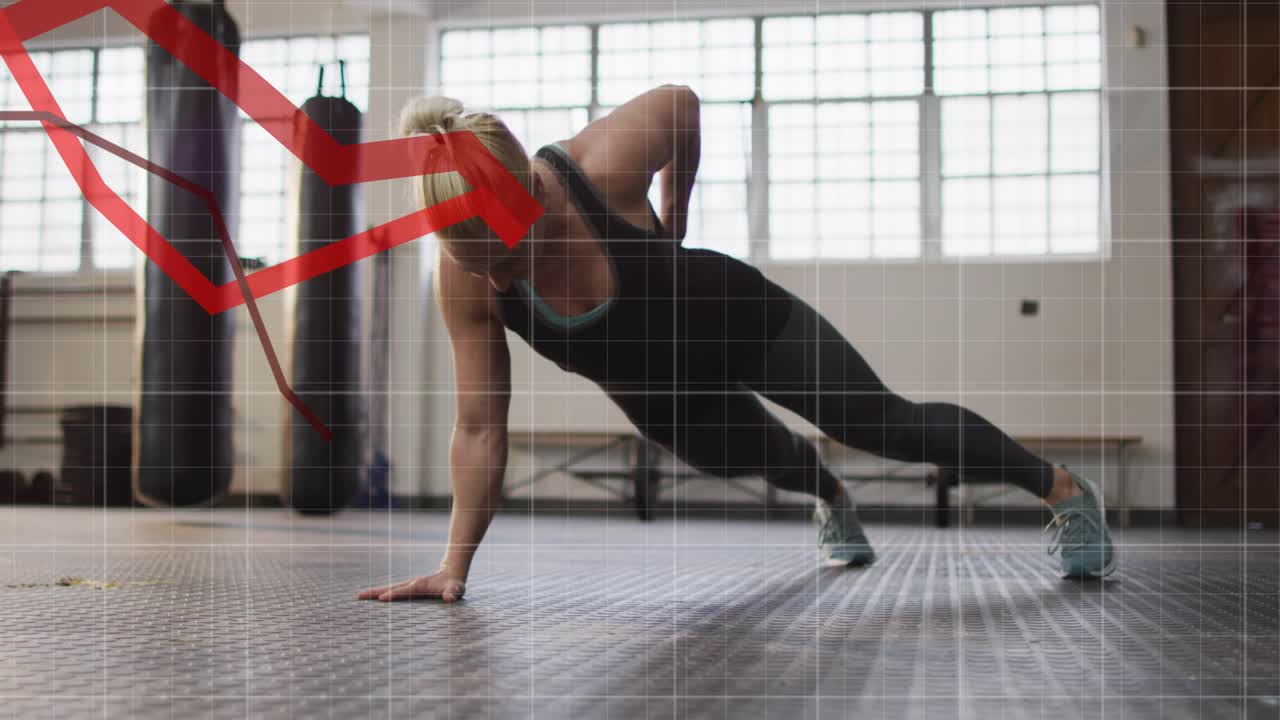 Woman shifting weight, lowering torso on gym floor, building core while grid and red line tracking