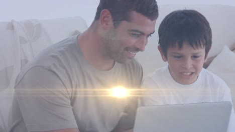 Animation-of-lights-over-happy-caucasian-father-and-son-reading-on-sofa