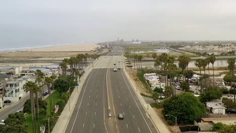 aerial view gliding down a coastal street to sparse summer traffic due to the covid 19 coronavirus outbreak