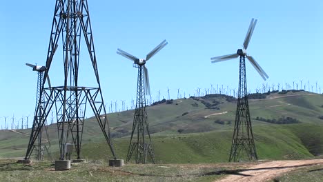 medium shot of four wind turbines generating power at tehachapi california