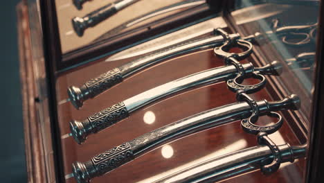 antique decorative knives in a display case