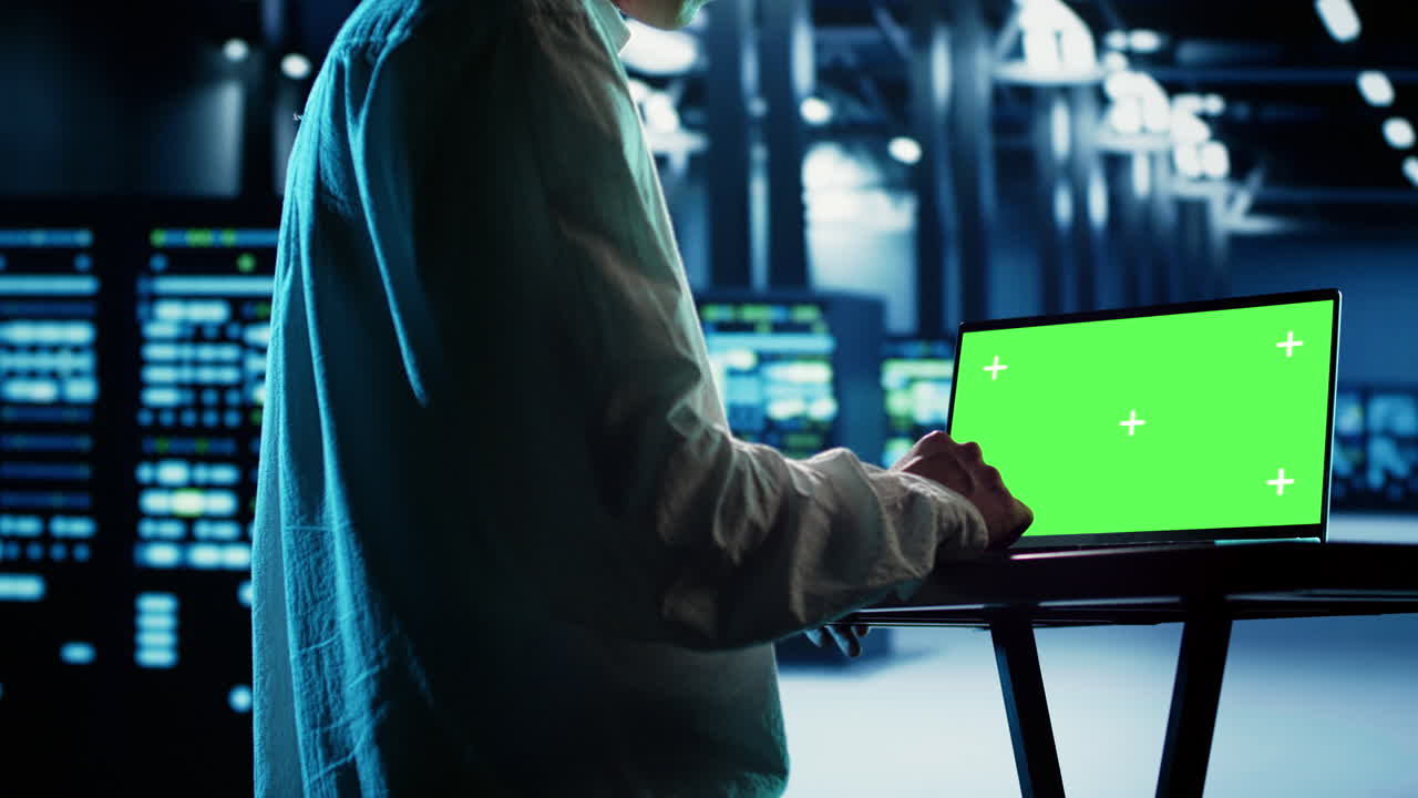 Technician uses chroma key laptop for AI