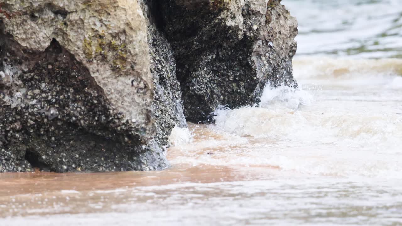 Waves hitting rocks at Ao Nang Beach