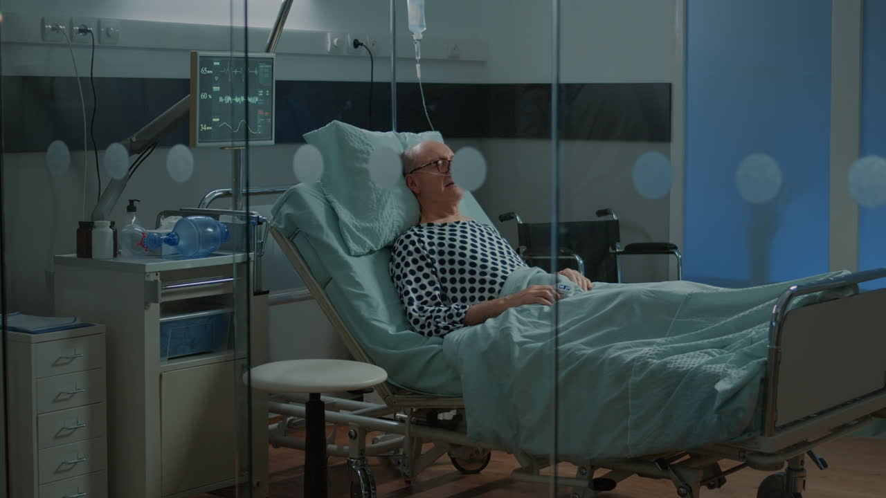 Old patient with breathing problems sitting in hospital ward