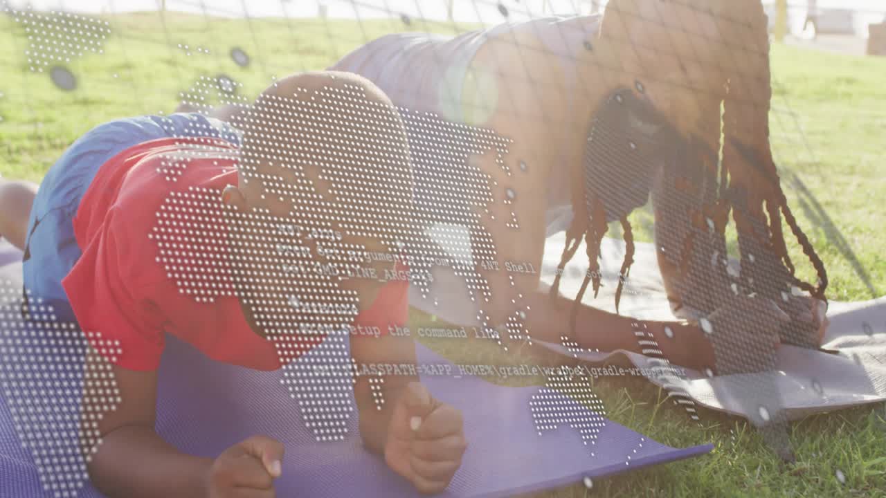 Father guiding son holding forearm plank on grass, encouraging while map or code overlaying faces