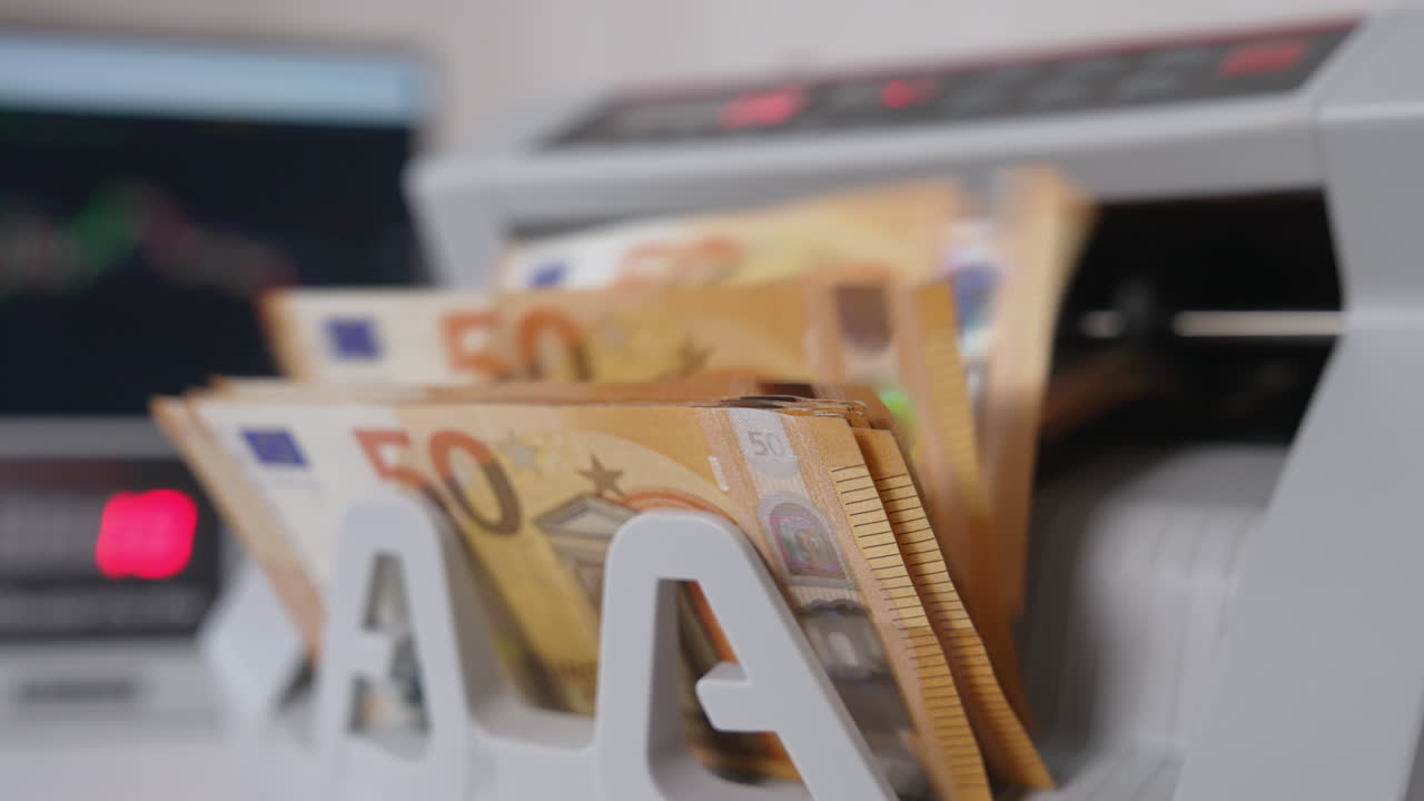 Starting a cash counting machine. European currency being calculated in the equipment. Financial operations concept.