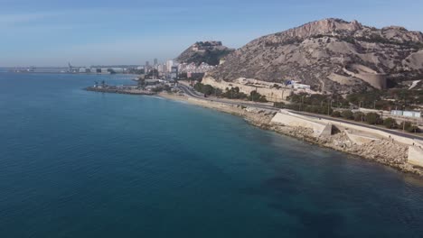aerial view of the coastal walk in the north of the city of alicante. sangueta mount and santa barbara castle in the background.