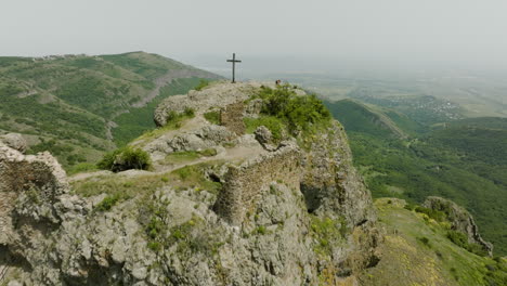 Aerial-dolly-in-shot-of-a-Christian-cross-on-top-of-the-Azeula-fortress