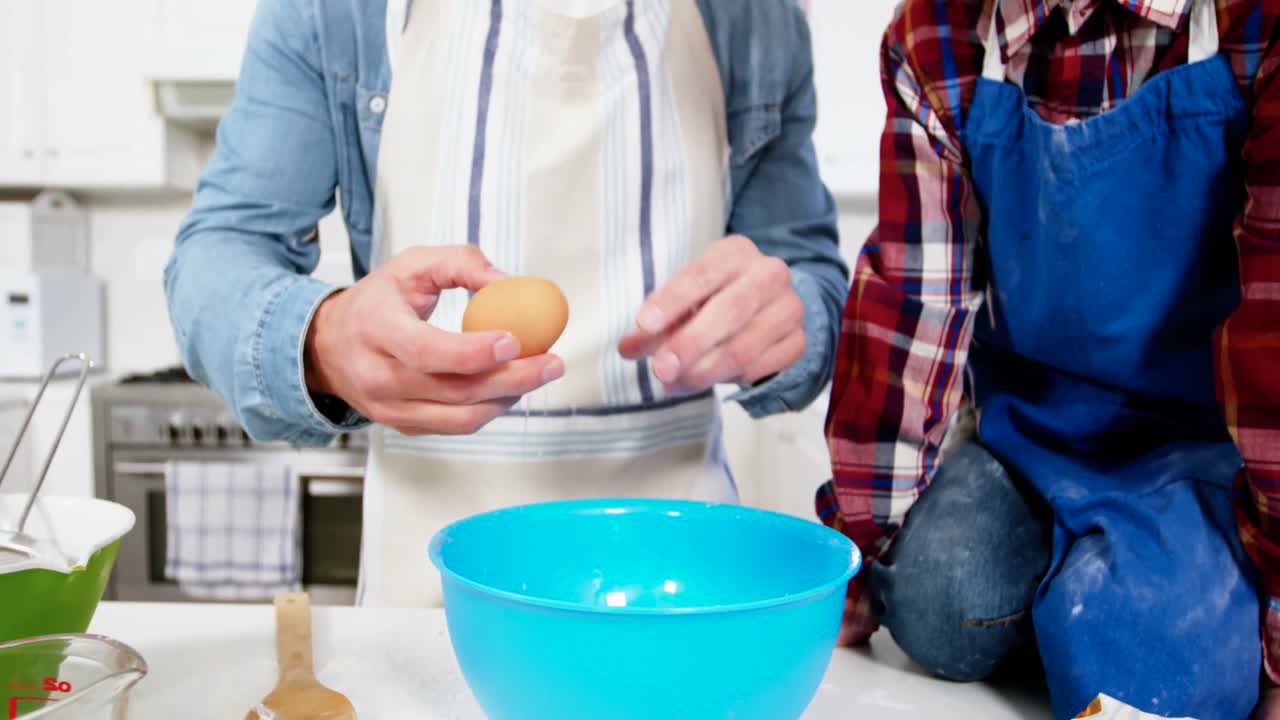 Father teaching his son how to make cupcake