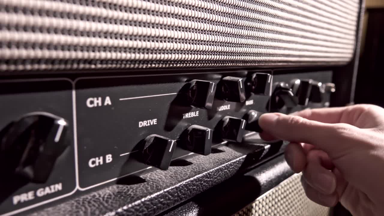 Musician adjust amplifier knobs to fine tune the output sound