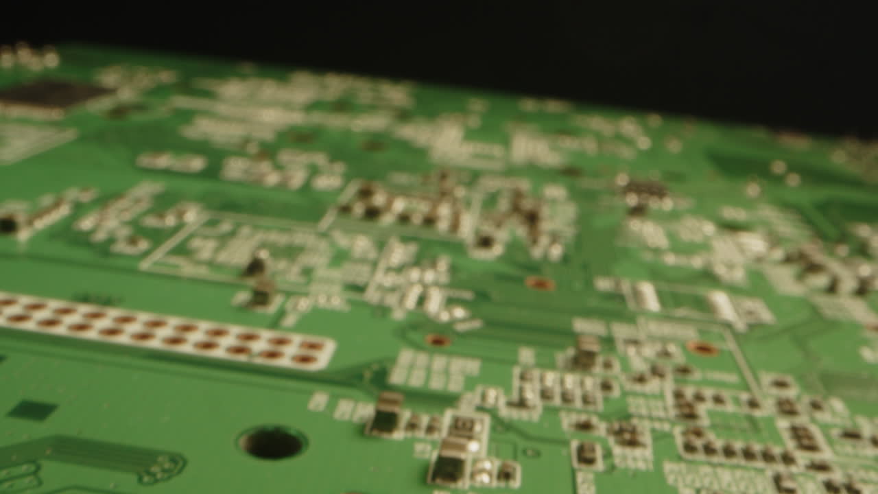 Extreme close up of a printed circuit board while the camera slowly moves out