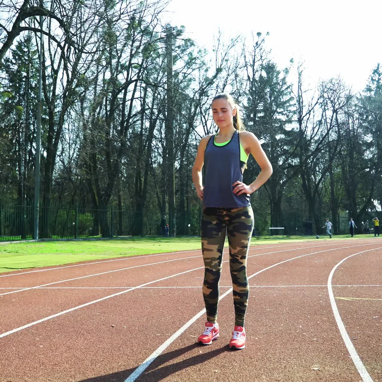 Runner athlete doing exercises at the stadium. Sports shoes. Healthy Lifestyle