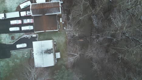 A-top-down-overhead-shot-of-a-neighborhood-in-the-winter-with-snow-covered-homes