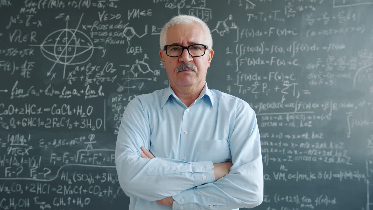 Teacher in front of a chalkboard full of equations