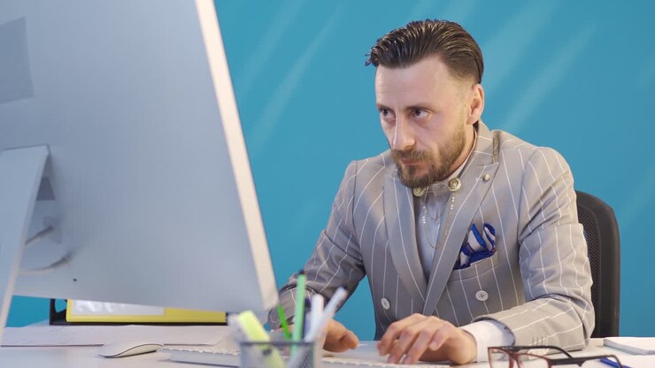 Stressed businessman working and biting his nails.