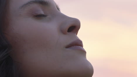 close up portrait of beautiful woman exploring spirituality looking up praying contemplating journey with wind blowing hair in countryside enjoying peaceful sunset